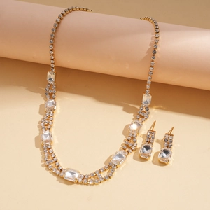 Macro view of crystal jewelry set with sparkling rectangular rhinestones and gold plating