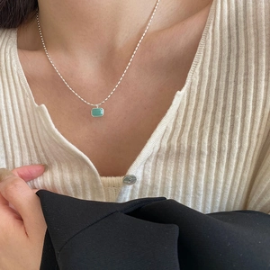 Detail of s925 silver necklace with green amazonite stone on a female model