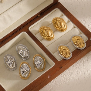 Lava irregular stainless steel stud earrings in gold and silver on velvet jewelry box
