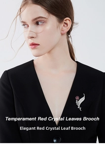 Close-up of leaf crystal brooch with red teardrop stone on black blazer lapel