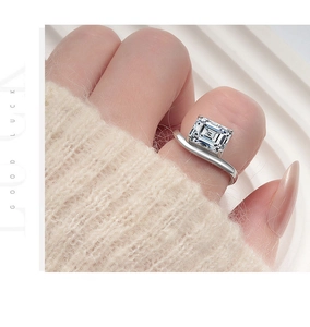 Macro view of sterling silver ring featuring a rectangle emerald cut diamond on hand