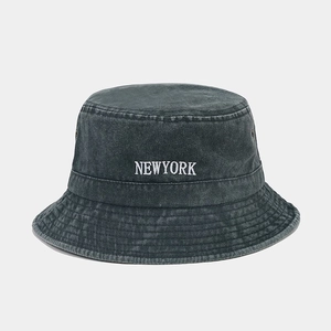 Close-up of white NEWYORK embroidery on vintage charcoal washed cotton bucket hat