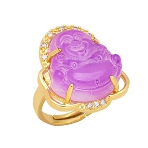 Macro detail of gold Buddha ring with purple stone and micro-pave crystal halo