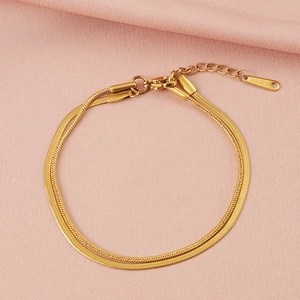 Detail of double-layer gold snake chain bracelet with adjustable lobster clasp closure