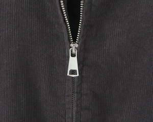 Close-up of premium vertical corduroy fabric texture and durable silver metal zipper detail