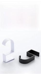 Detail shot of black and white S-shaped portable desk hooks for hanging bags