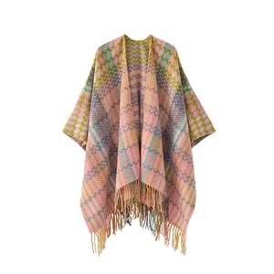 Ethnic style knitted shawl cape with colorful stripes and fringe trim on white background