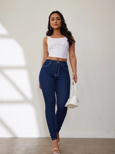 Detailed close-up of dark blue high-waisted skinny jeans in stretch denim fabric