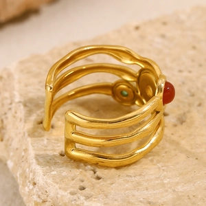 Detail of 18K gold-plated double-layer ring featuring a central red zircon stone