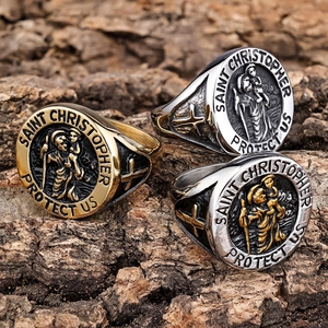 Saint Christopher rings in gold, silver, and two-tone finishes on rustic wood bark