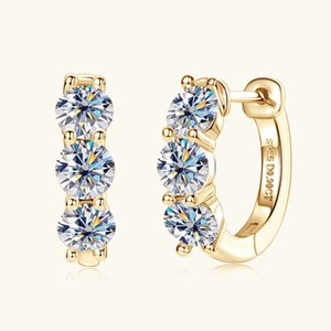 Macro detail of gold S925 silver hoop earrings with three brilliant-cut round moissanite stones