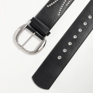 Detail of vintage black leather belt with silver D-ring buckle and metal rivet accents