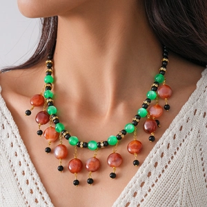 Ethic bohemian layered tassel necklace with green resin beads and gold accents
