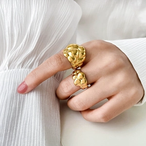 Gold plated 18K stainless steel lava ring with fluid textured abstract design on hand