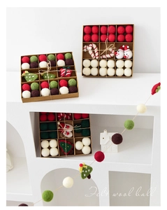 Detailed close-up of handmade wool felt Christmas ornaments with snowman and tree motifs
