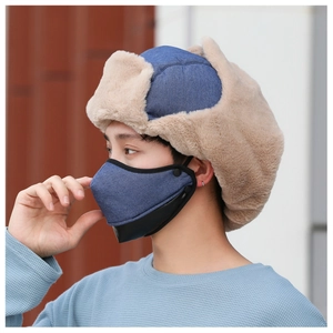 Detail of blue winter trapper hat with thick faux fur lining and matching face mask