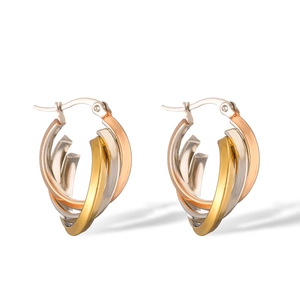 Detailed shot of twisted 18K gold plated hoop earrings in gold, rose gold and silver