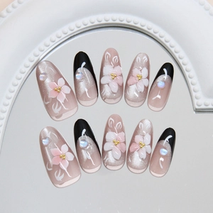 Handmade camellia cat eye press-on nails with 3D floral designs and black French tips