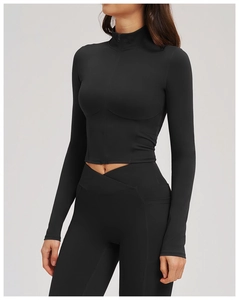 Detail of black cross waist yoga leggings with functional side pockets and fitted zip jacket
