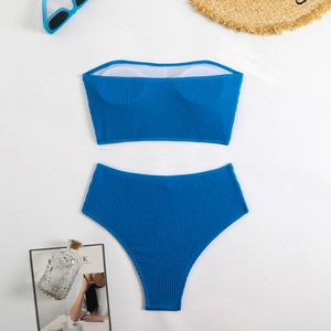 Royal blue two-piece bikini with honeycomb texture fabric, sun hat and vacation accessories