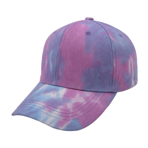 Detail of colorful tie-dye baseball cap featuring pink blue and purple twill cotton fabric