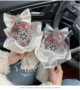 Close-up of Christmas apple bouquets with silver snowflakes and large bow decorations