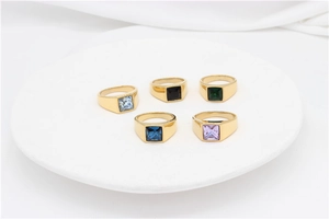 Macro view of five colorful square gemstone rings with gold-plated titanium steel settings
