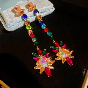 Macro shot of colorful pear-cut rhinestone earrings with sparkling rainbow stones