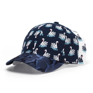 Detail view of navy blue baseball cap with swan prints and camouflage brim pattern