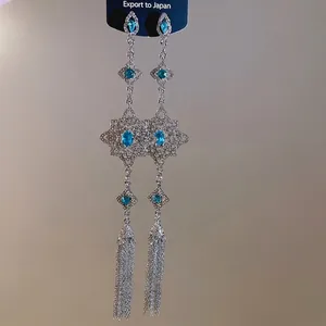 Elegant silver tassel earrings with blue rhinestones and vintage bohemian hollow design