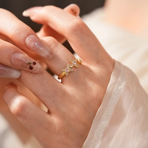 Close-up of vintage golden ring featuring zircon star patterns on a model finger