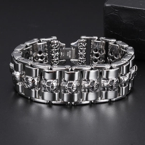 Macro detail of silver stainless steel skull link bracelet with embossed metal textures