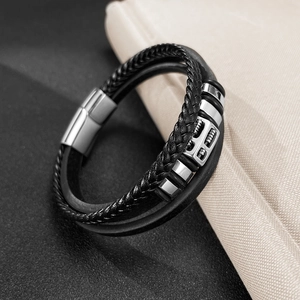 Detail of multi-layer black braided leather bracelet with silver magnetic metal clasp