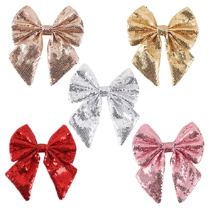 Set of five glittery Christmas bow ornaments in gold, silver, pink, and red for tree decor