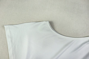 Detailaufnahme von grauem Strickstoff mit Rundhalsausschnitt und Schulternähten