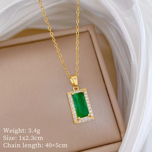 Macro shot of gold necklace with green rectangular gem and dimensions text