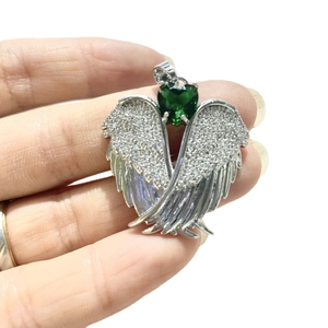 Silver angel wing pendant with green heart gemstone and zircon micro-pave setting