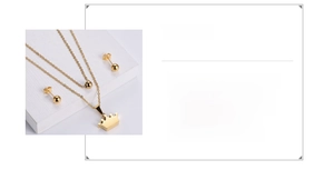 Close-up of 18K gold plated stainless steel crown pendant and matching ball stud earrings