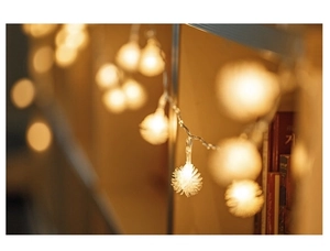 Detail of warm white fiber ball fairy lights in a cozy indoor home decor setting