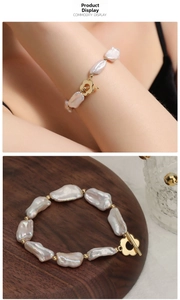 Detail view of Baroque pearl bracelet with golden floral OT clasp on wooden tray