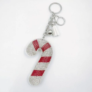 Detail of candy cane keychain with red and white rhinestones, silver bell and tassel