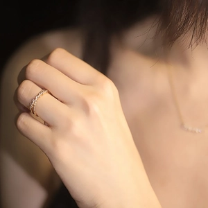 Detailed close-up of 18K gold plated double-layer cross ring with pavé diamond settings