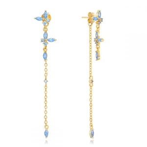 Detail of long gold tassel earrings with sky blue stones in a delicate floral design