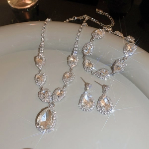 Silver luxury necklace and teardrop crystal earrings set with sparkling stones