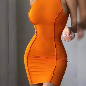 Detail of orange ribbed knit dress featuring halter neck and decorative exposed seams