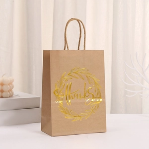 Brown kraft paper gift bag with golden wreath design and Thank You text detail