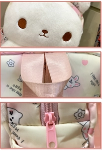 Detail view of white plush rabbit backpack with pink straps and Hero slogan print