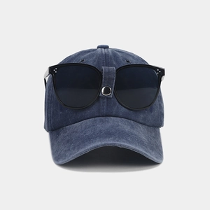 Detail of navy blue vintage baseball cap with integrated sunglasses and silver metal buckle