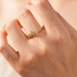 Close-up of vintage gold star ring with lavender gemstones on model's finger