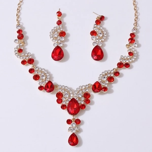 Detail of luxury bridal jewelry set with red pear-cut crystals and gold finish